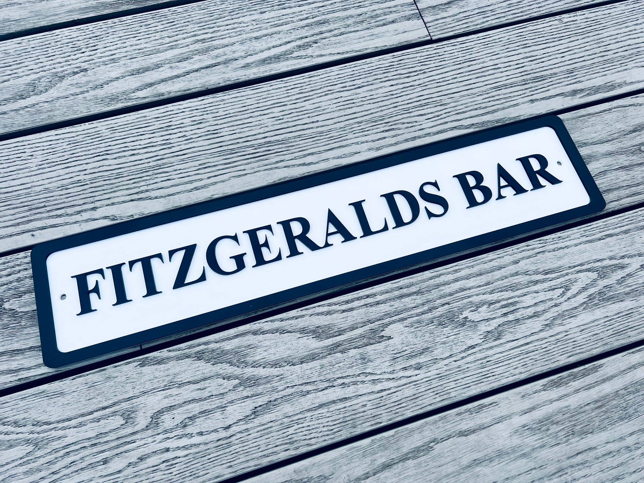 Personalised bar name sign mounted on outdoor wall, perfect for home bar, man cave, or garden pub decor